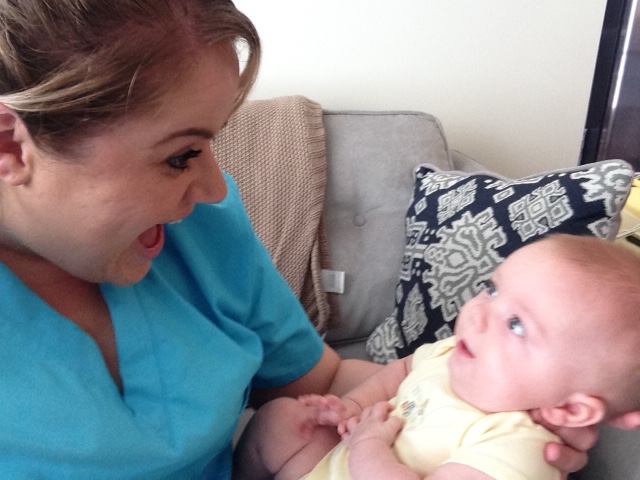 Night Nurse and newborn baby smiling at each other