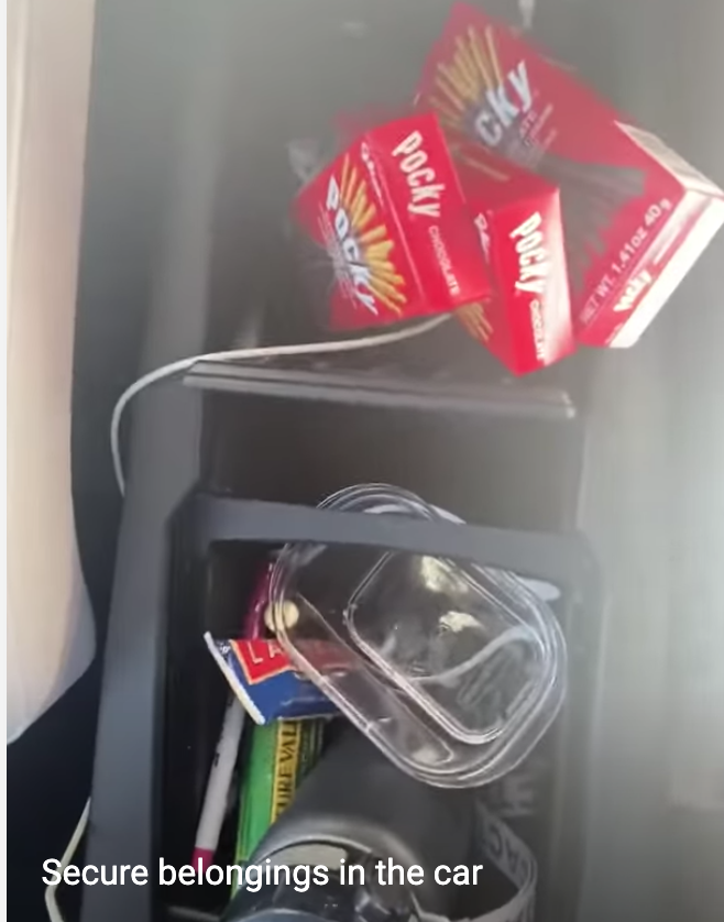 car console filled with snacks, phone charger as potential projectiles