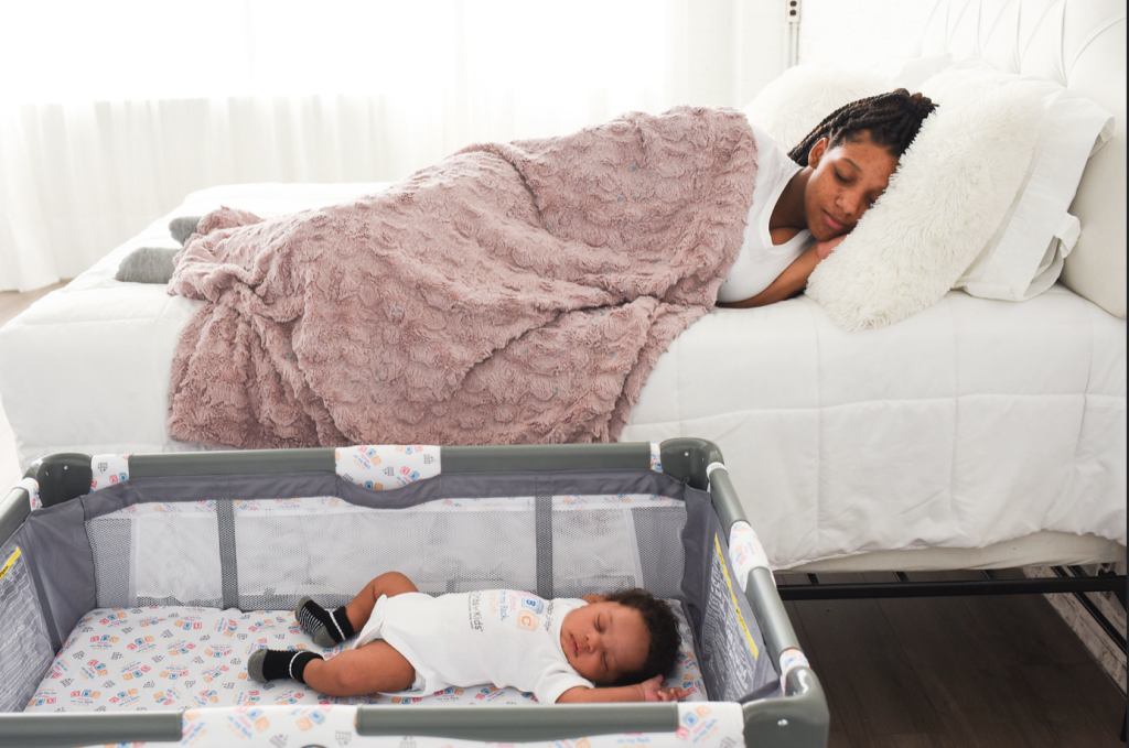 newborn sleeping in crib, postpartum mom in bed
