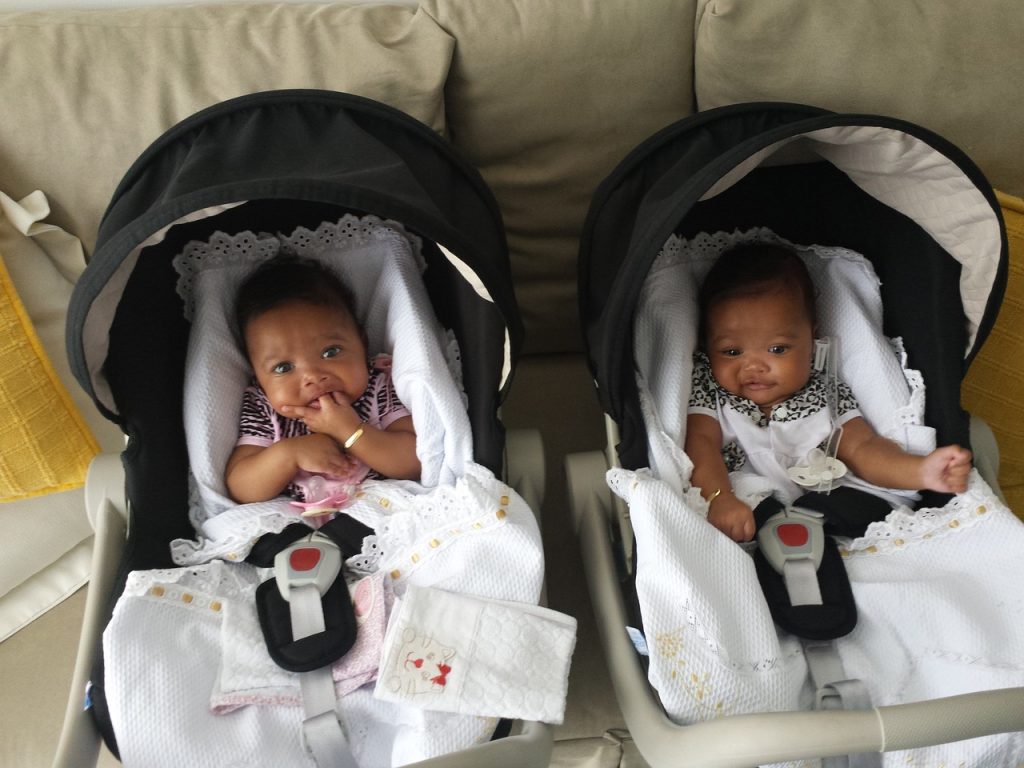 Newborn twin girls  in carseats. 