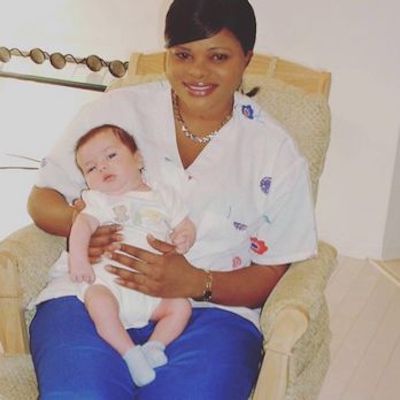 newborn care certified doula and baby. night doula holding baby upright