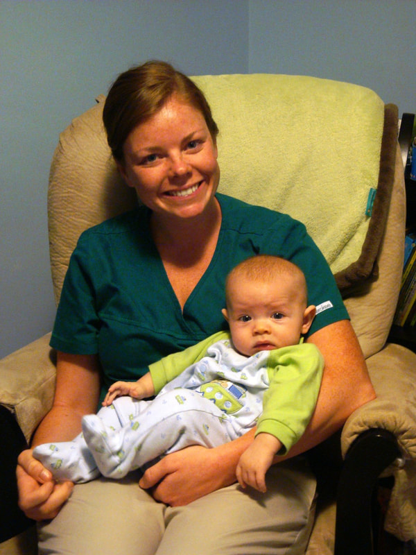 RN holding newborn to help in debunking myths about night doulas and families being strangers.