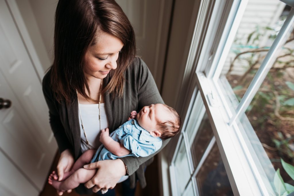 Postpartum Employee Benefits Programs show a mom holding newborn