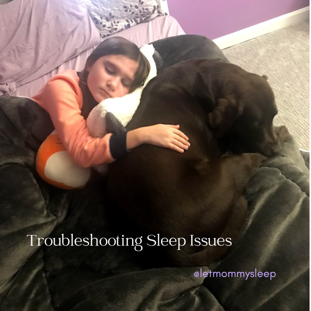 older child sleeping peacefully with chocolate lab by her side